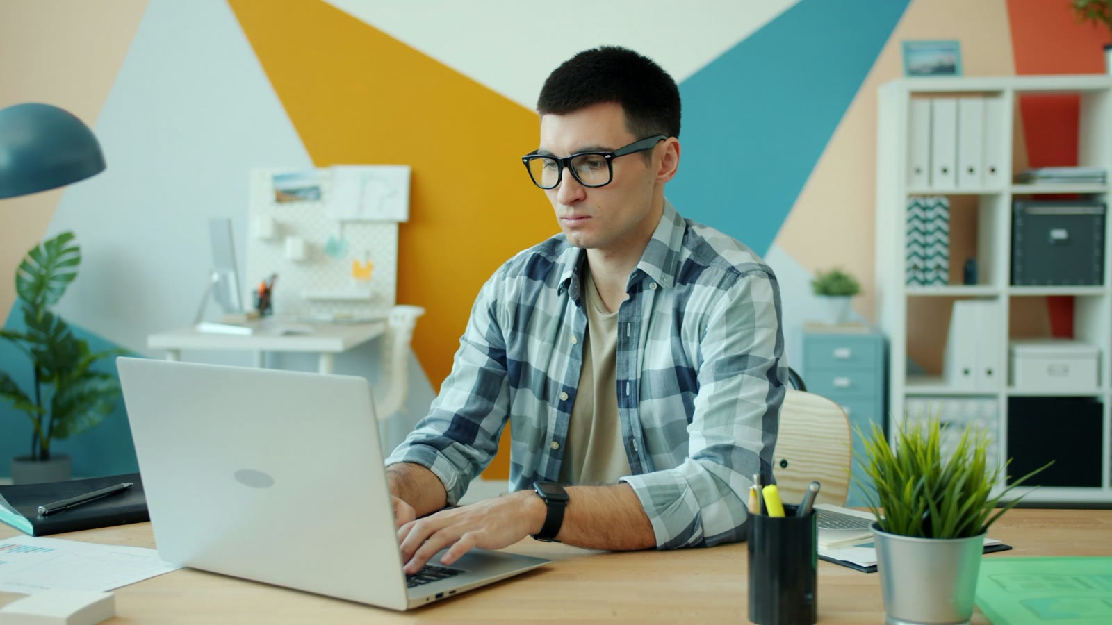 A man focused at his laptop, preparing to negotiate a job offer