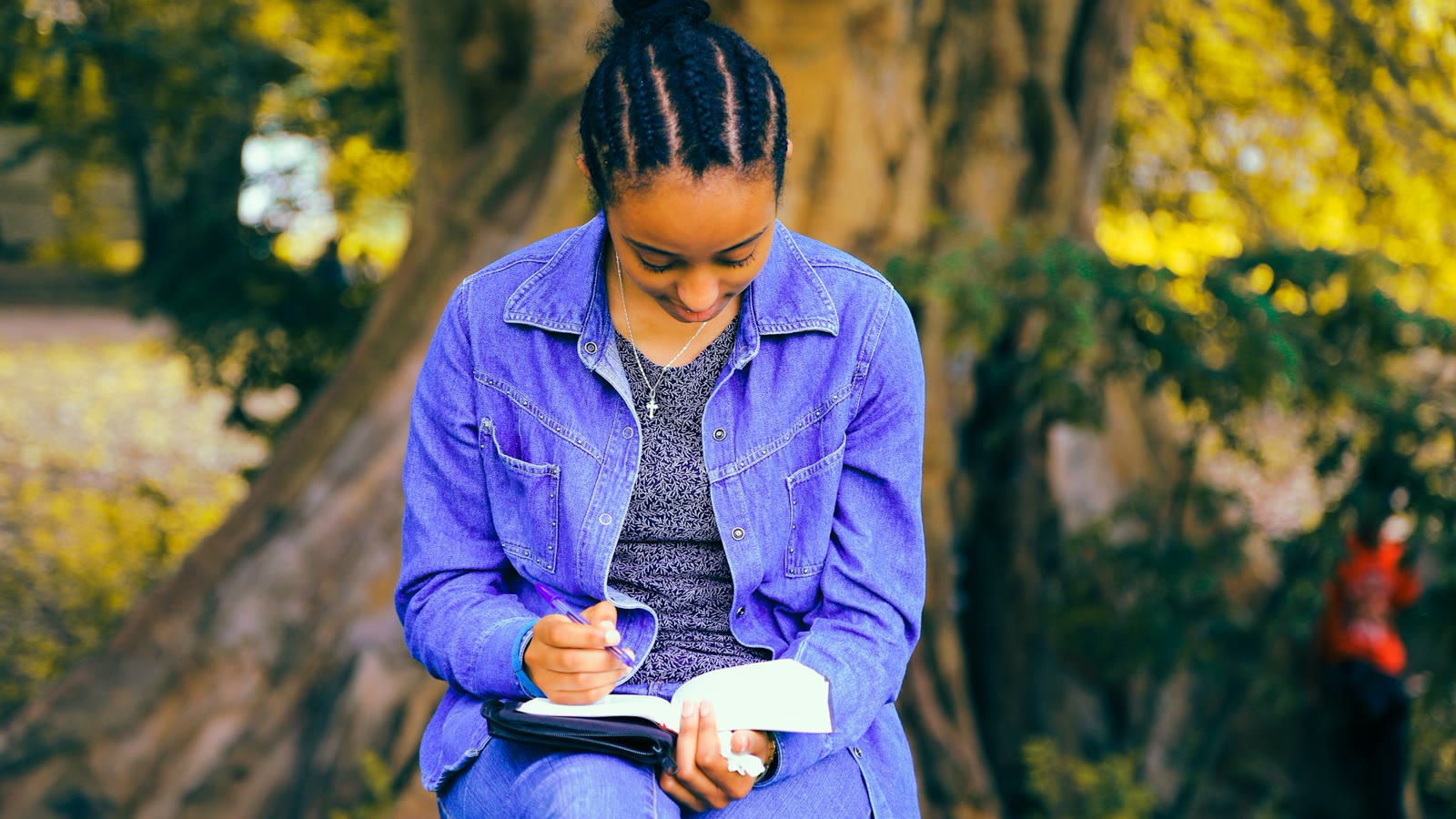 A woman writing out a career plan in a notebook